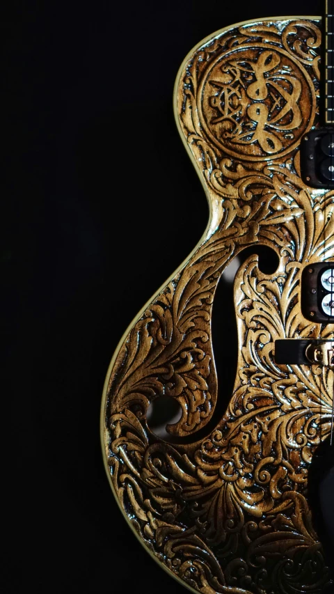 a golden and intricate guitar with a clock in its center