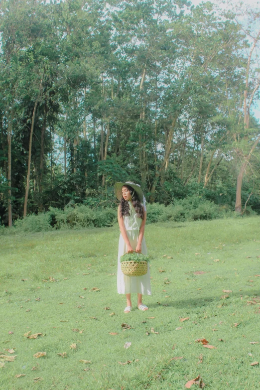 a woman standing in the grass wearing a dress