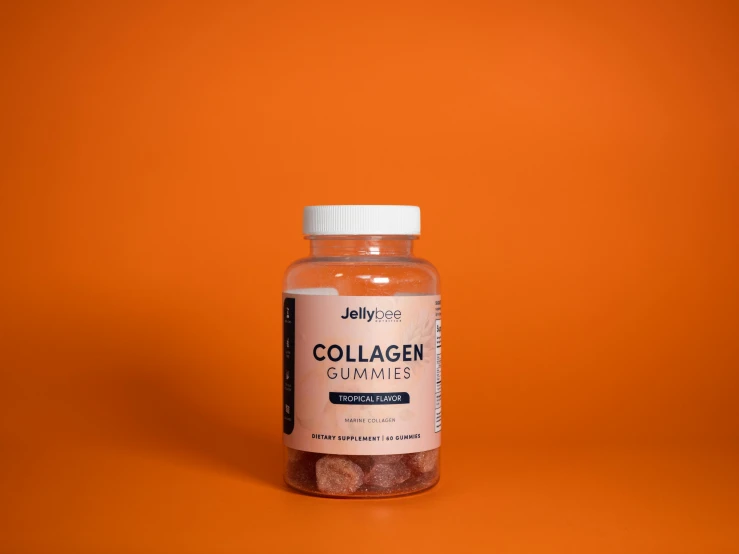 a bottle of collagen orange tablets on an orange background