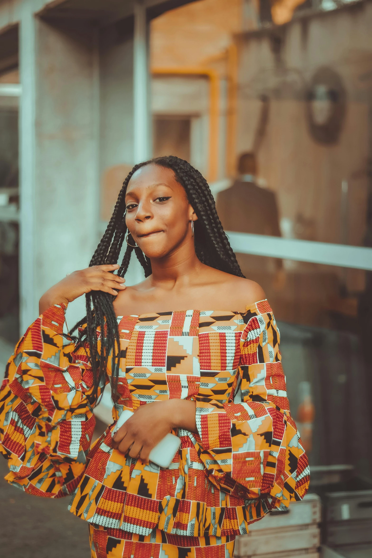 a woman standing outside and looking at the camera