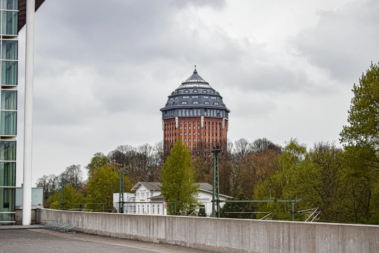 a tower is seen through the fence of an urban area