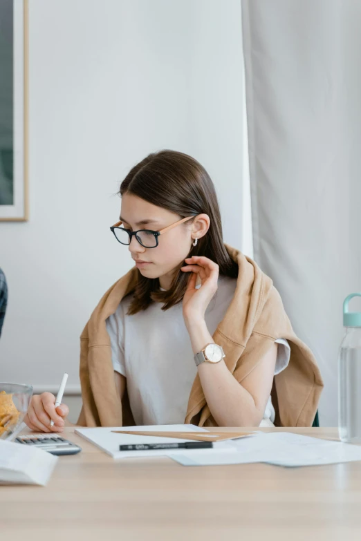 young woman at work taking notes on her lunch