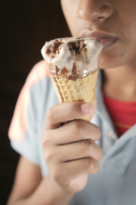 a close - up of a person eating an ice cream cone