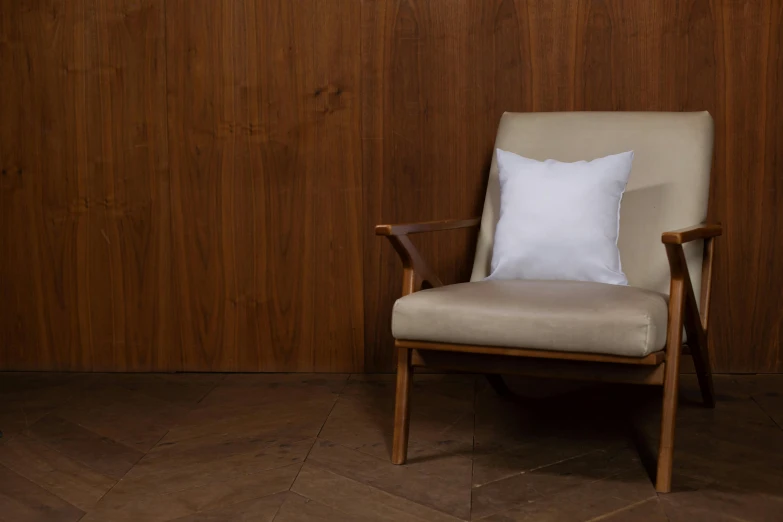 a wooden chair with a white pillow sitting next to it