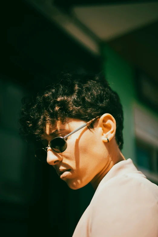 a young man wearing sunglasses and a shirt