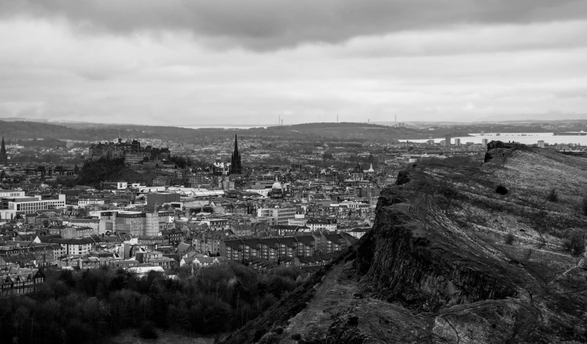 black and white pograph of a city with mountains