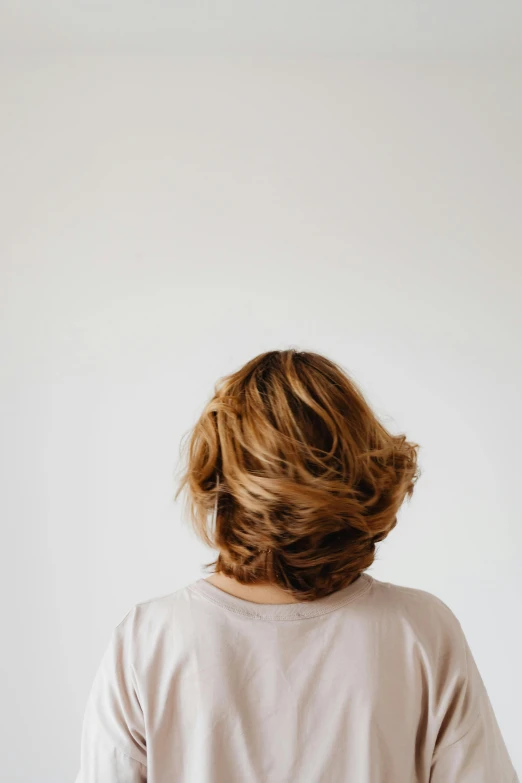 woman with wavy hair in short sleeve top