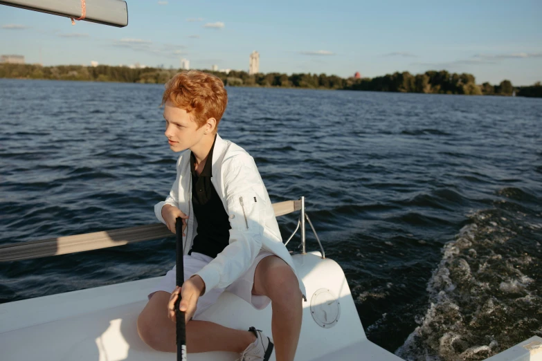 a man on the back of a boat sitting in the water