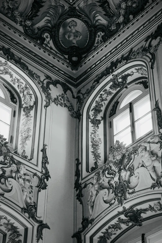 two windows with ornate decor on the ceiling