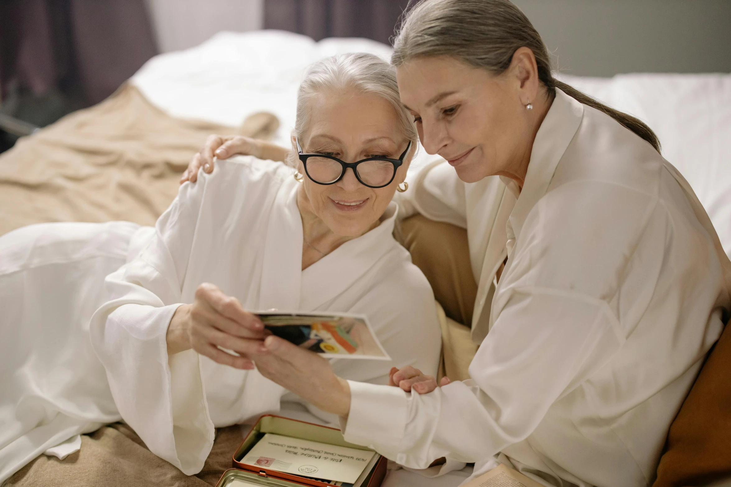 two women standing in a room looking at soing