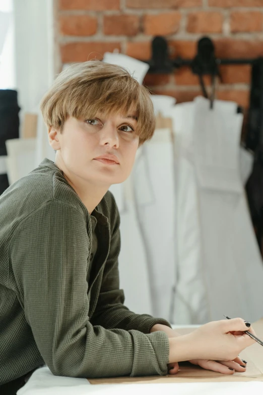 young man in front of dress on display at clothing store