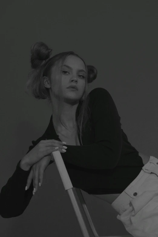 woman leaning on a chair wearing a shirt