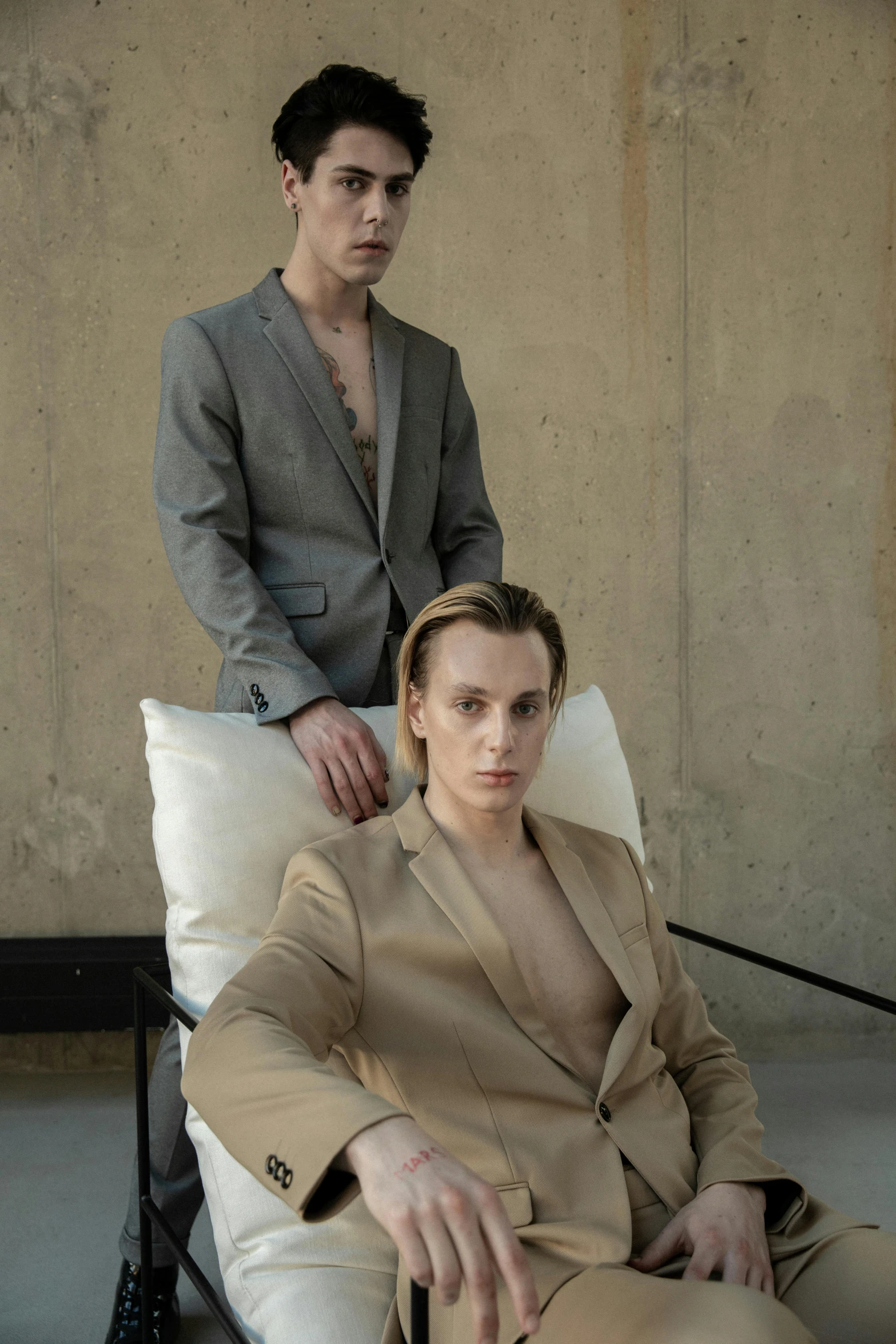 a woman sitting down next to a man in a suit