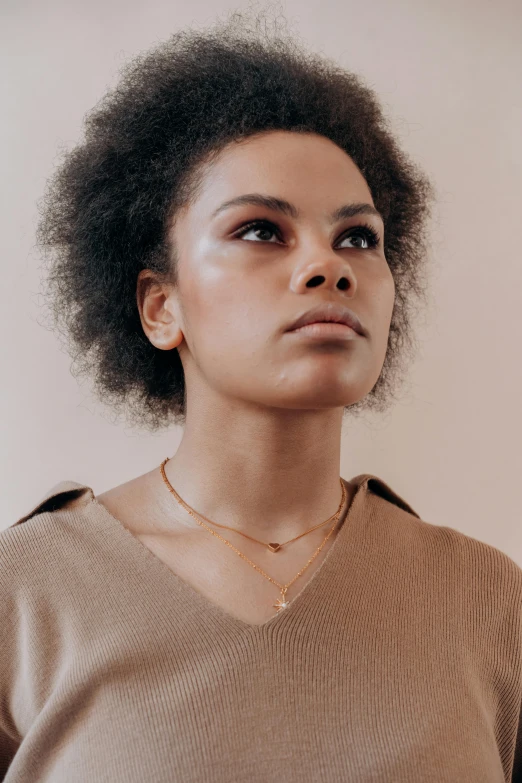 a woman with short hair standing looking up