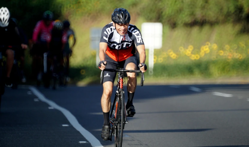 a cyclist is wearing a helmet and riding in a race