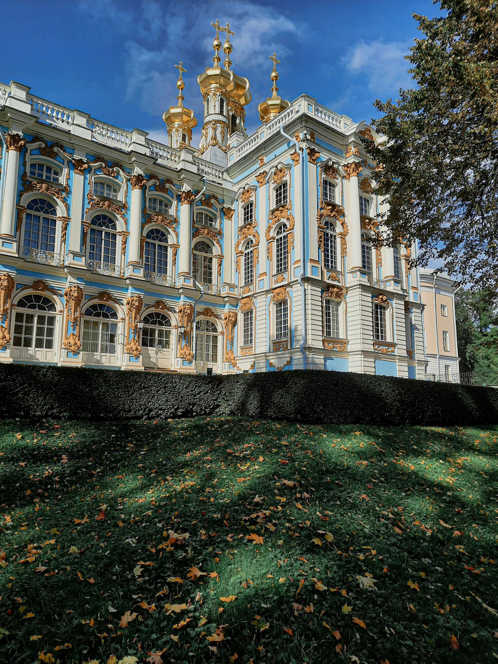 the facade of a building with golden and blue design