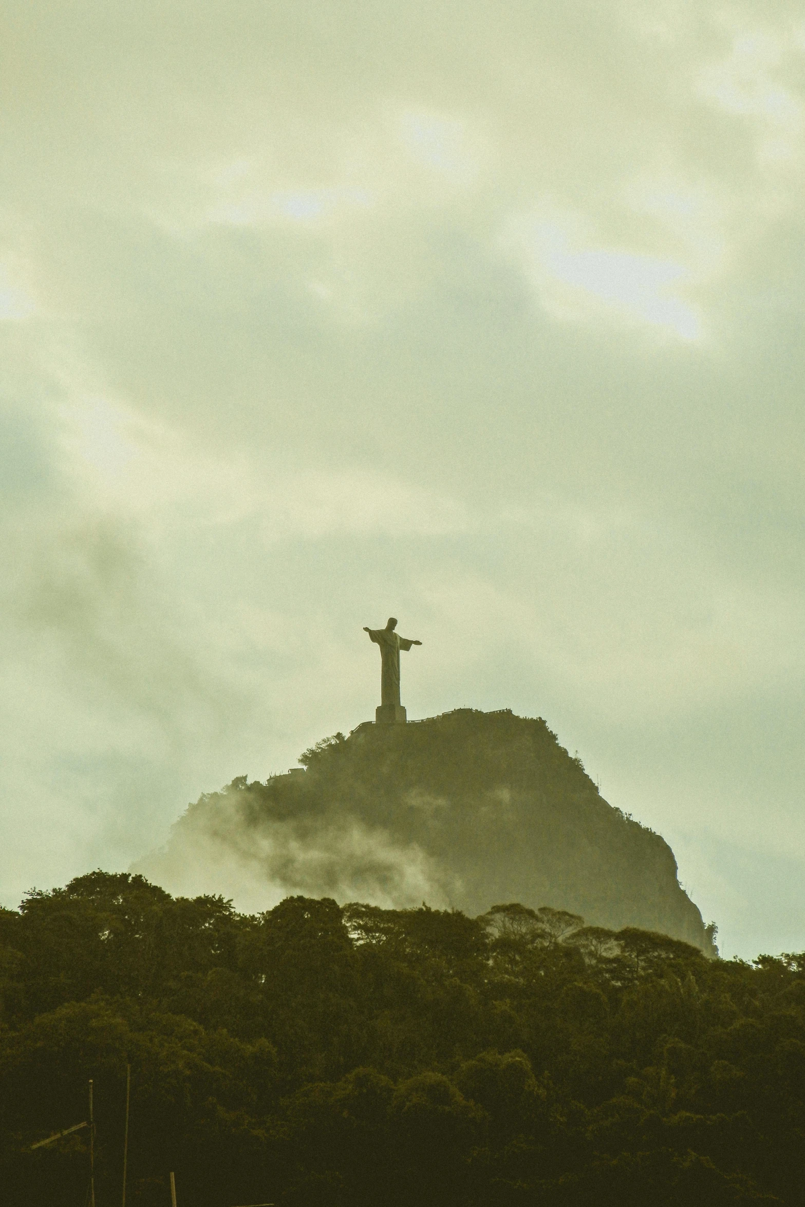 a tall hill that has a cross on top