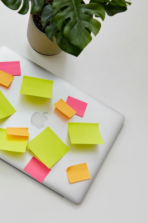 colorful sticky notes are on a computer monitor