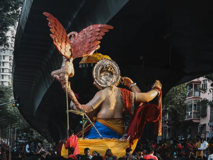 a man in costume holding a giant bird