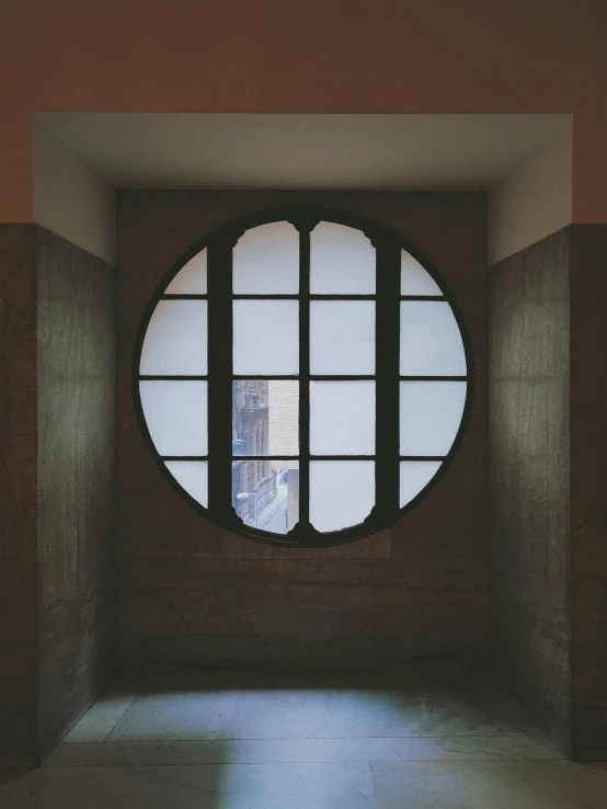 an arched window is in the middle of a wall