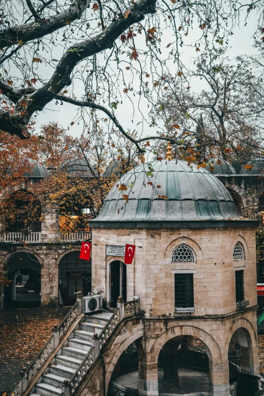 a building in an old city that has some trees on it