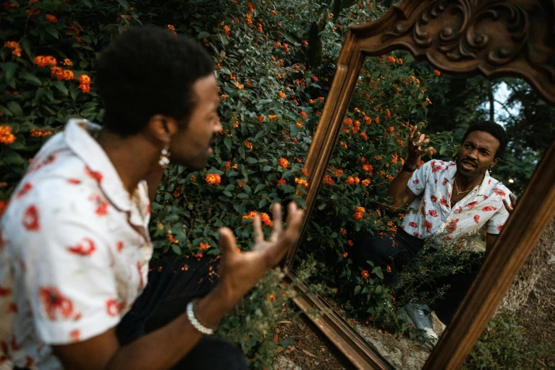 two men are sitting in front of a mirror