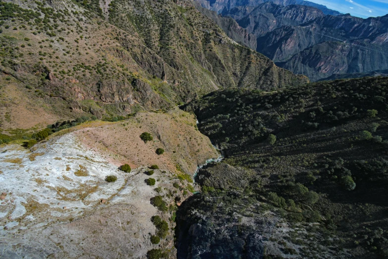 a cliff on the side of a mountain with a stream in it