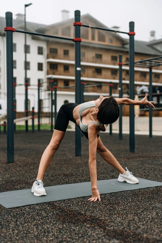 woman is doing a co pose on her yoga mat