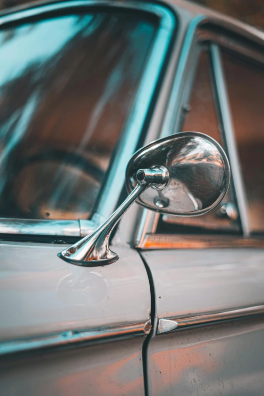 a silver mirror on the side of a car