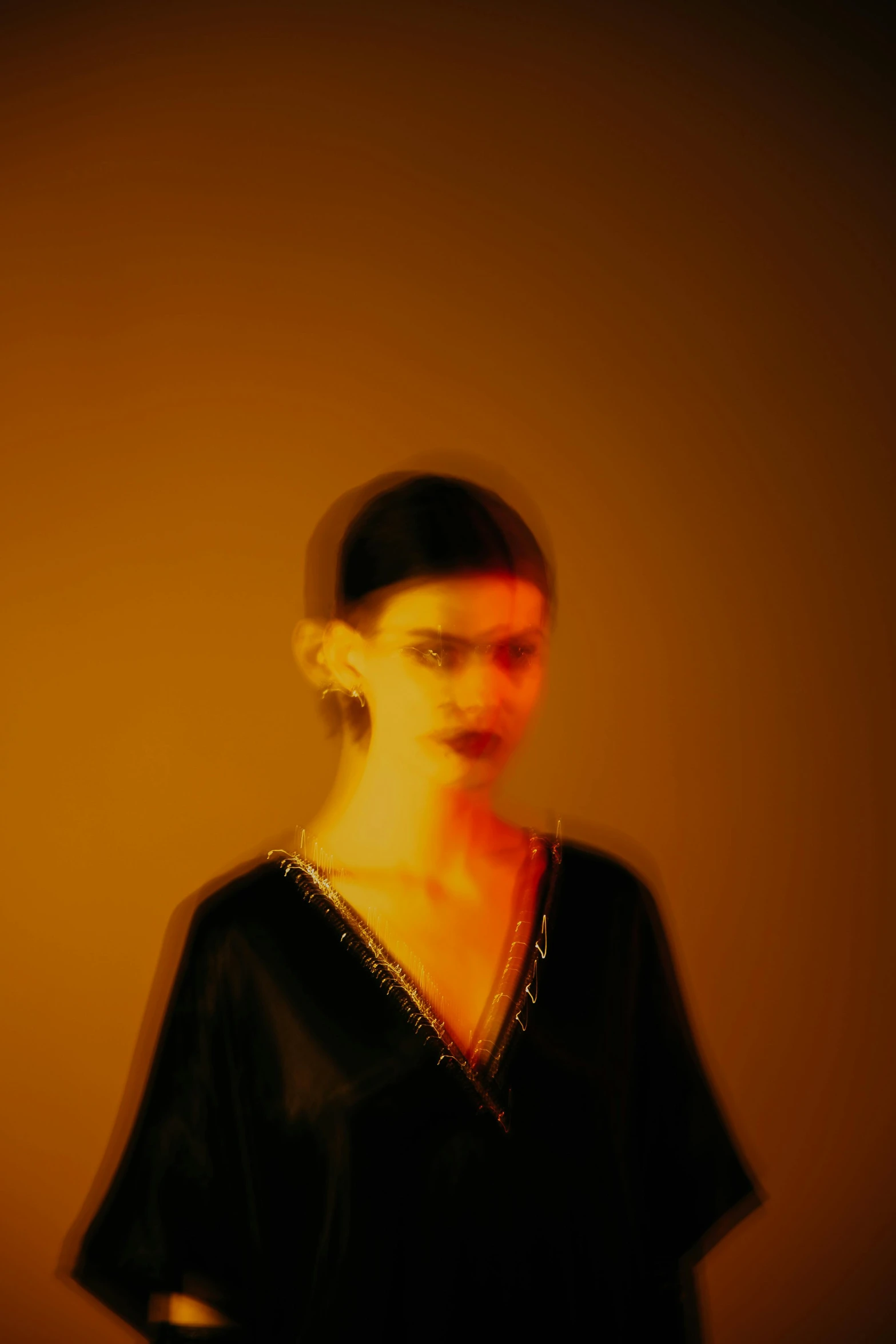 a blurry pograph of a woman in a black top