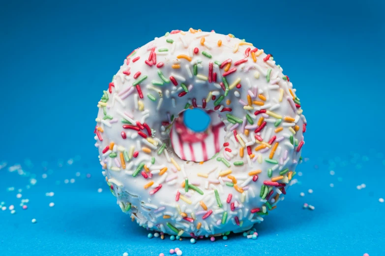 a frosted donut with colorful sprinkles on it