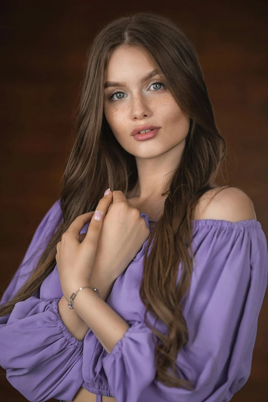 a beautiful young lady posing in front of a black backdrop