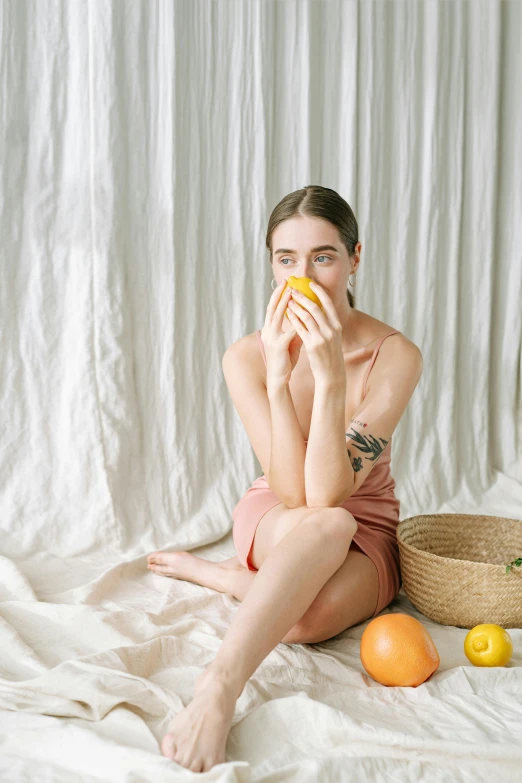 a women who is eating some food and sitting on a bed