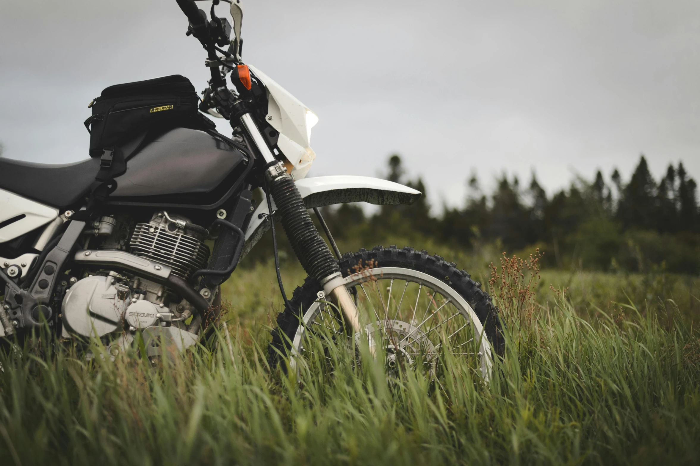 a motorbike is parked outside in the grass