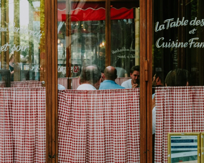 an image of people sitting at tables in the window