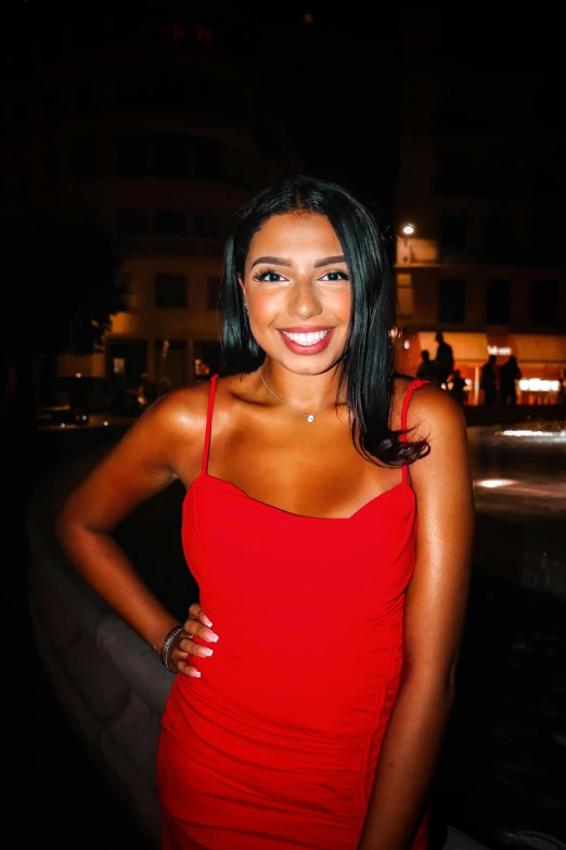 young woman in red dress posing for pograph