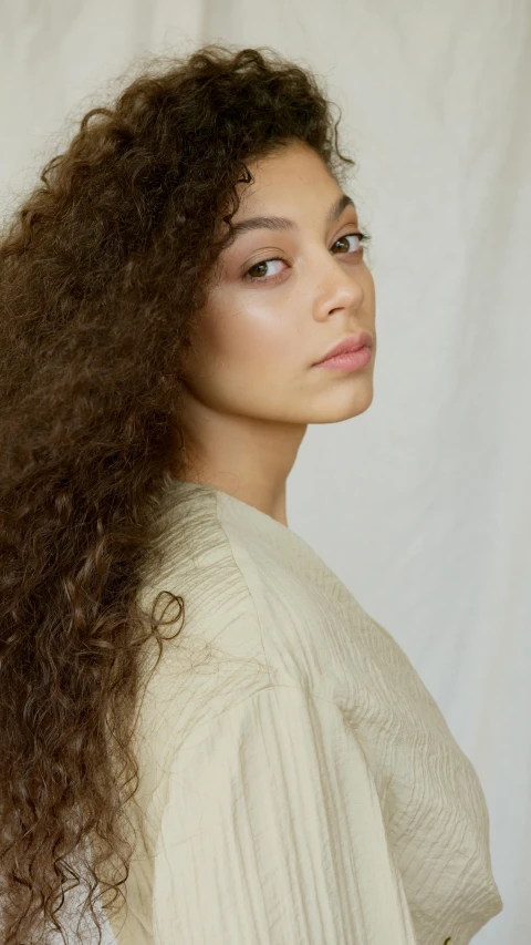 a beautiful young woman with large brown hair