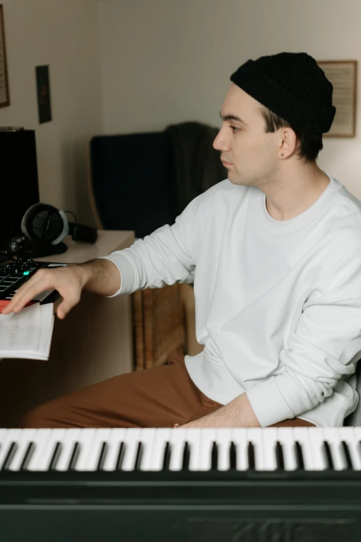 a man that is sitting down and playing a piano