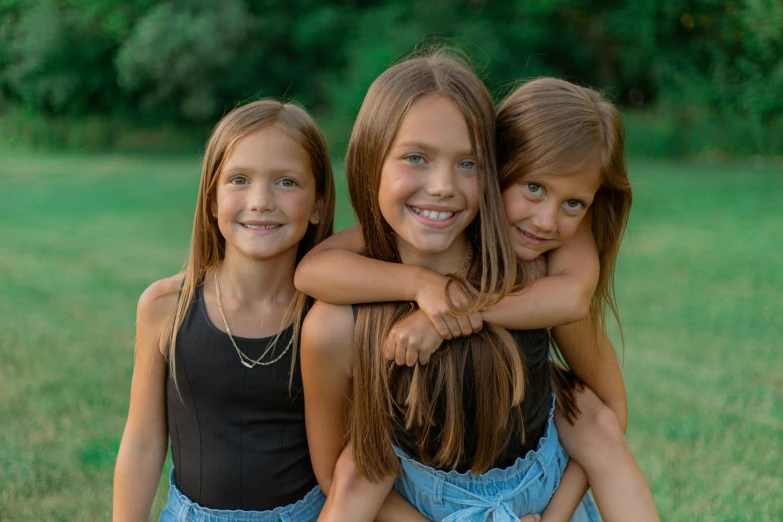 four small girls smile while emcing each other