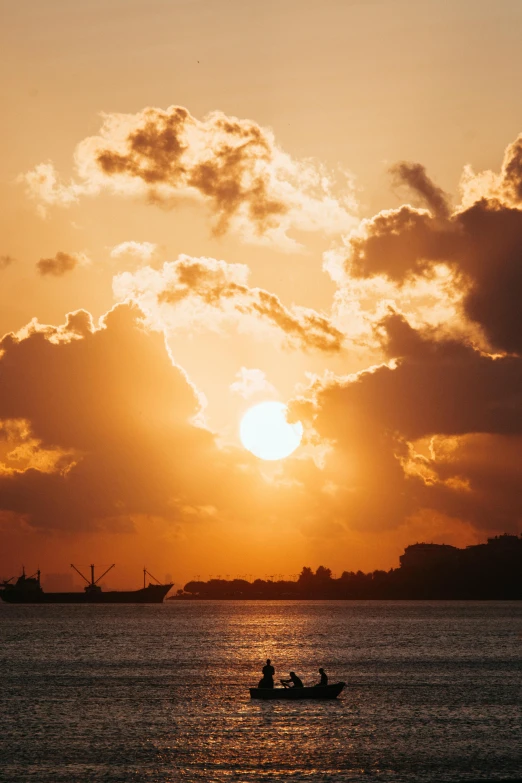 people in the water at sunset near a boat