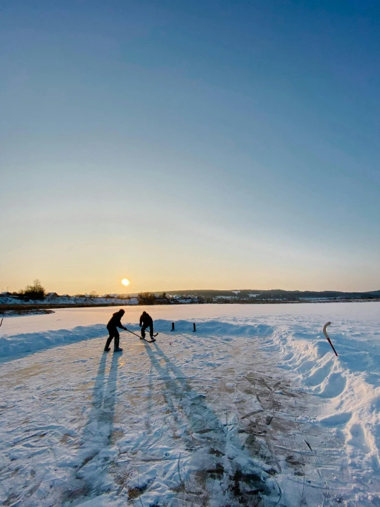 the two people are playing in the snow