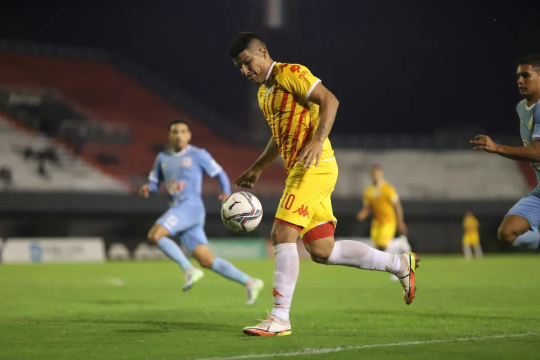 a soccer player is kicking a soccer ball during a game