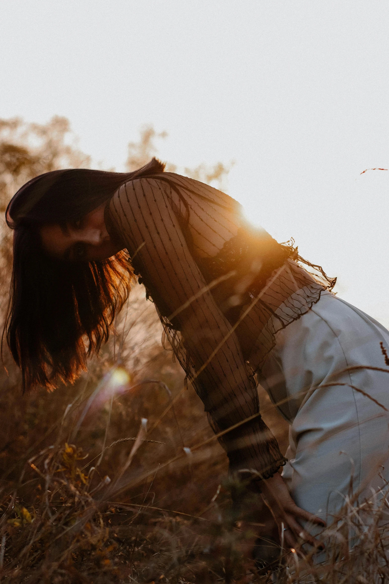 a man laying on the ground in grass