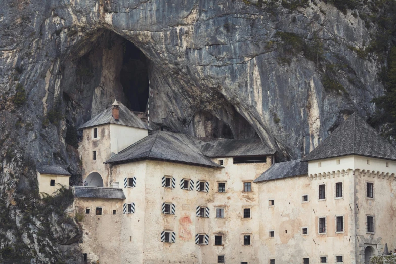 two tall building surrounded by mountains and rocks