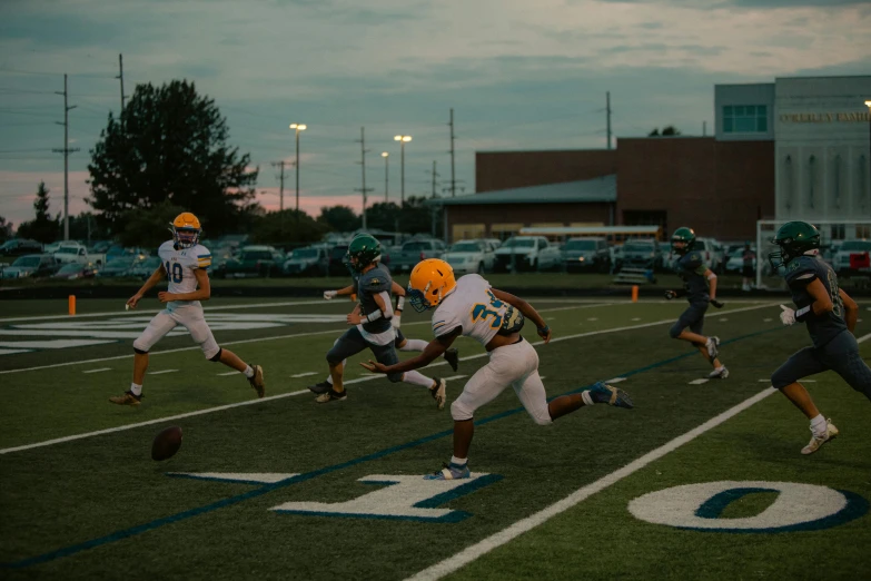 a couple of guys are playing football together