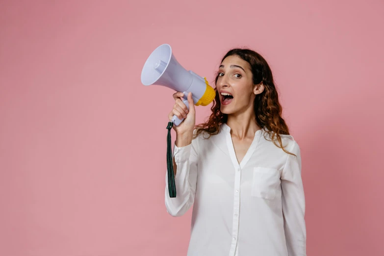 a young woman is shouting into a megaphone