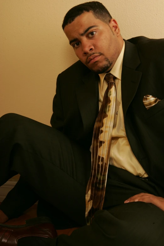 a man dressed in a suit is posing for the camera