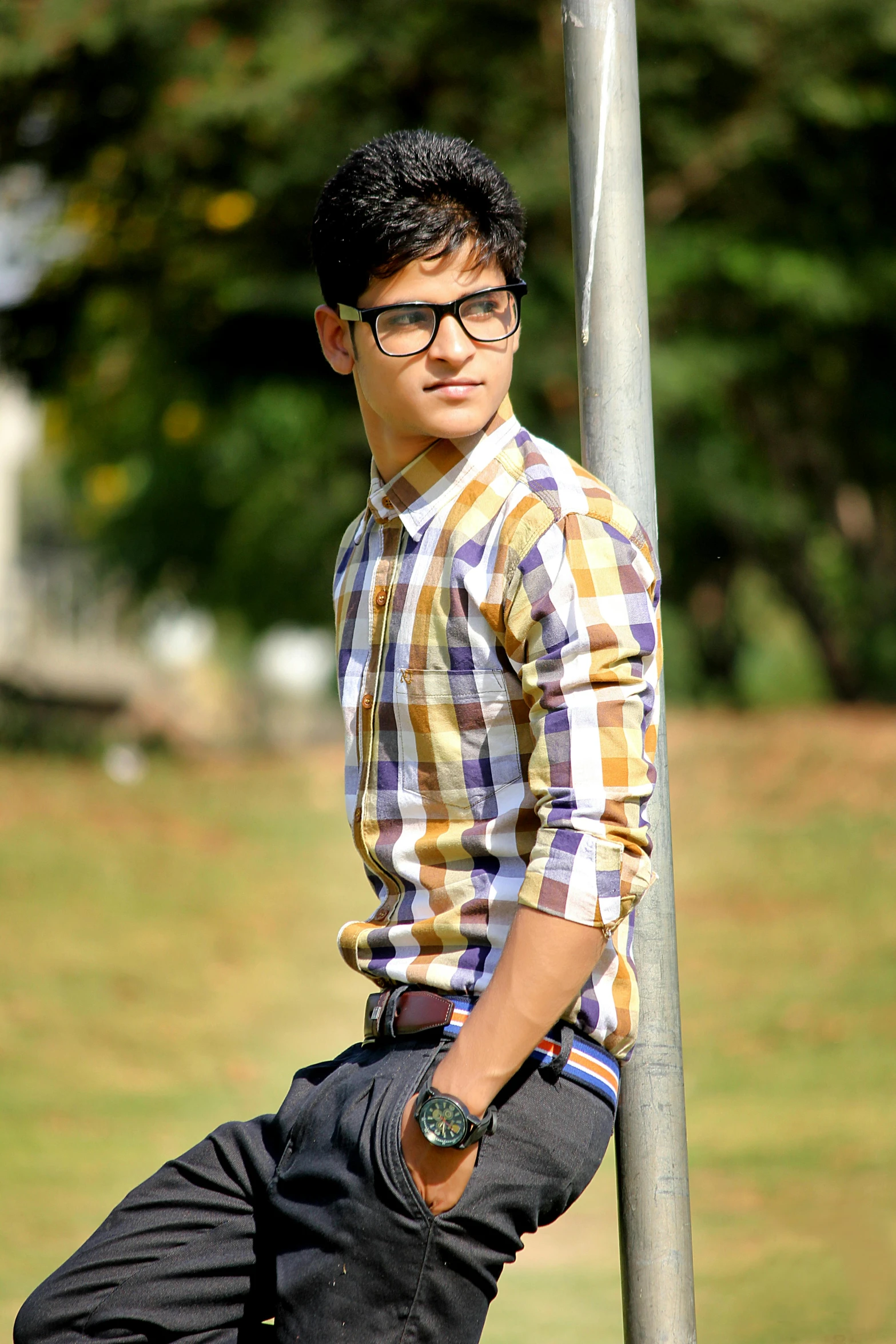 a man in glasses poses for a picture