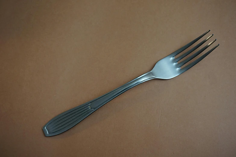 a close up of a fork on a table