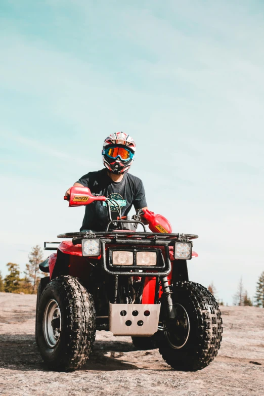 a person on an atv driving on dirt